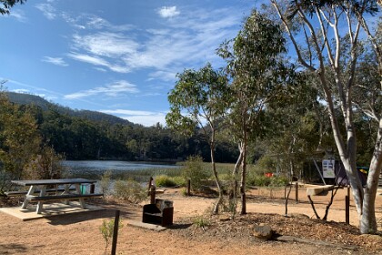 Dunn's Swamp Ganguddy  27/09/25   A fireplace: what an ideal setting for a get together with friends or family. There are many camping spots available right now and the drop toilet doesn't smell at all - well, hardly at all.  The building on the right houses a kayak rental organisation; they were shutting up for the day.