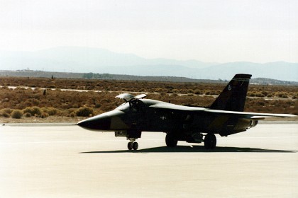 An F111 taxis out for a flight presentation. It has a crew of 2 who sit side by side.