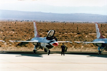 A Thunderbird F16 pilot enters his plane.