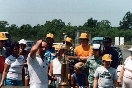 Ted gets dunked with Champagne for his troubles. The Walker Cup is in front of Ted.