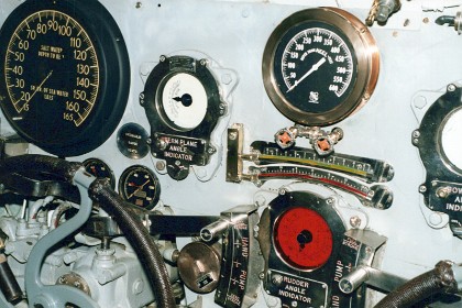 Various navigational instruments and other controls.  Looks like the steering wheel at the bottom left of the picture.