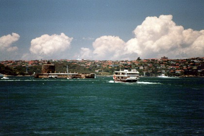 The convict built stone building in the middle of the harbour on the left is called Fort Dennison or Pinchgut.  The British soldiers, who ran the rum trade in early Sydney, would hang and gibbet prisoners on this island . It was also a prison where they would be fed bread and water only.  In late 1796 the Governor installed a gibbet on Pinchgut. A convict hanged and gibbeted there was to serve as a warning to other convicts.  Such is Christian Mercy.