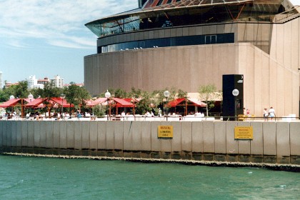 An open air restaurant is that the front side of the Sydney Opera House.