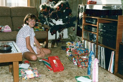 This is Lee, my sister Joan's daughter.  Lee sorted everyones' presents into piles to make distribution much, much quicker.  December 25, 1986.