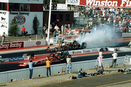 The top fuel semi-final.  Joe Amato warms up his tyres; Darrell Gwyn is his rival.  Noise from a top fuel dragster shakes your rib cage; it's wonderful, unbelievable.