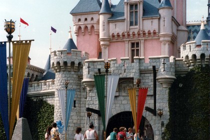 A princess sitting outside of Sleeping Beauty's Castle.