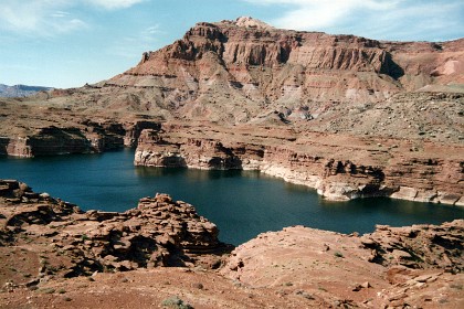 The lake was created by the damming of the Colorado at Glenn Canyon Dam in Page, Arizona.  Quote:   "Glen Canyon Dam is quickly becoming a relic of the past. While there may be too much concrete to fully remove the dam, it will eventually need to be re-engineered in order to preserve the remaining biological integrity of Grand Canyon and the Colorado River."