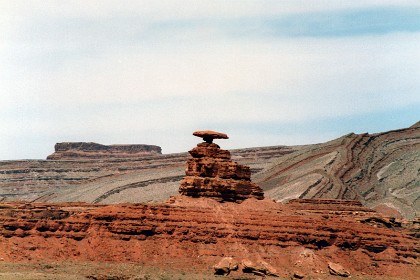 This is Mexican Hat Rock at Mexican Hat, Utah. Note the squeezing of the rocks in the background. According to Google, in 2022 the rock is still balancing there just as it was 35 years ago. You gotta wonder for how much longer?