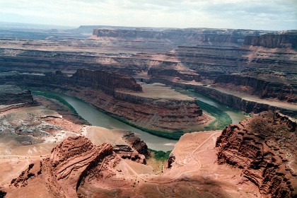 This is Dead Horse Point that, according to legend,  is so named because of its use as a natural corral by cowboys in the 19th century, where horses often died of exposure. Dead Horse Point is at an elevation of 5900 ft and the Colorado River below is around 2000 ft.