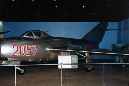 Mikoyan-Gurevich MiG-15bis. The Soviet Union developed the MiG-15 following World War II and the fighter entered service in 1949. By 1952 the Soviets provided the MiG-15 (NATO code name "Fagot") to a number of communist satellite nations, including North Korea. In 1950 the Soviets began production of a more capable version, the MiG-15bis. The MiG-15bis used a more powerful engine and hydraulically boosted ailerons. During the Korean War, both versions of the MiG-15 operated extensively against United Nations forces. TECHNICAL NOTES:  Armament: Two 23mm cannons and one 37mm cannon plus rockets or 2,000 lbs. of bombs Engine: Klimov VK-1 of 6,000 lbs. thrust (developed from the British Rolls-Royce "Nene" engine) Maximum speed: 670 mph Range: 500 miles Ceiling: 51,000 ft.  Span: 33 ft. 1 1/2 in. Length: 33 ft. 3 5/8 in. Height: 11 ft. 2 in. Weight: 11,270 lbs. maximum Serial number: 2015357