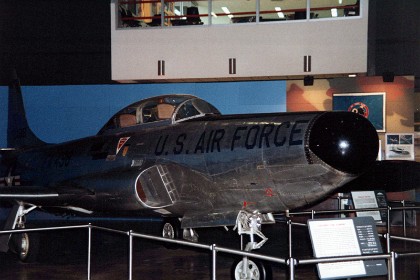 Lockheed F-94A Starfire. Developed from the T-33 Shooting Star, the two-place F-94 was the first American all-weather jet interceptor and the first U.S. production jet to have an afterburner. The large radar in the nose permitted the observer in the rear seat to locate an enemy aircraft at night or in poor weather. The pilot then flew the Starfire into proper position for an attack based upon the observer's radar indications.   TECHNICAL NOTES: Armament: Four .50-cal. machine guns Engine: Allison J33 of 6,000 lbs. thrust with afterburner  Maximum speed: 630 mph Range: 930 miles Ceiling: 42,750 ft. Span: 38 ft. 9 in. Length: 40 ft. 1 in. Height: 12 ft. 2 in. Weight: 15,330 lbs. Serial number: 49-2498