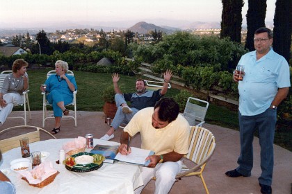 Bruce signs the book they give me. Lowell Balzum on the right is one of Bob Crawford's managers at Rancho Bernardo.