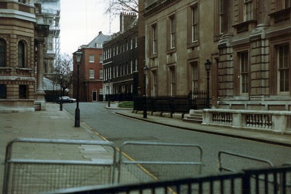 The gloomy black residences Numbers 10 and 11 Downing Street, homes of the PM Margaret Thatcher and the Chancellor of the Exchequer. When I was here in 1973, you could walk up to the front door.  Number 10 is approximately 3⁄4 mile (1.2 km) from Buckingham Palace and near the Palace of Westminster, the meeting place of both Houses of Parliament.