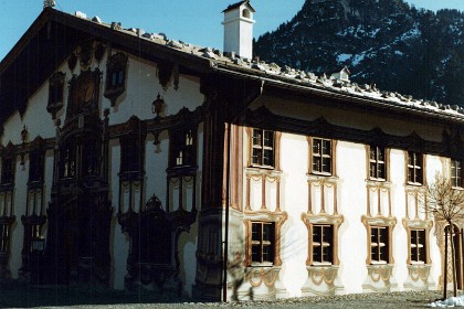 I never learn why some houses in Bavaria have rocks on their roofs. Note the ornate decoration around the windows, especially at the front.