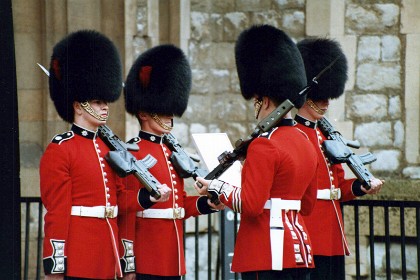 Changing the guard at the tower. These are Coldstream Guards: buttons in pairs, red plume, badge on collar.