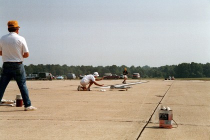 Don McLave launches Ted Fancher's plane during the flyoffs.  Gary McLellan is judging.