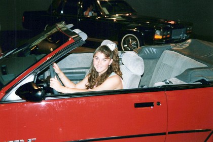 Cheryl sits one of the less bland GM cars, a Pontiac Sunbird. The engines were the carryover 2.0L 96 hp four and the turbocharged 165 horsepower 2.0L four.