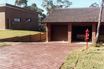 The log wall still stands thirty years later but the drive way doesn't look as clean as this any more.