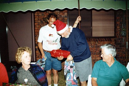 Santa Tim hands out the gifts.