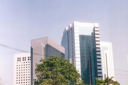 Street level restaurants contrast with modern skyscrapers.