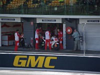 Chaz DAVIES (57) with Alex BARROS' Ducati in the garage next door.