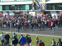 After the MotoGP race, a fine tradition is where the crowd assembles on the track for the podium ceremony.