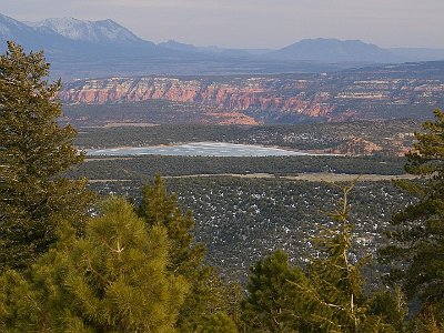 This part of Utah is a land of contrasts. There is a frozen lake in the foreground, the desert canyons and 11,500 ft Henry Mountains in the background.