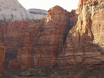 The sandstone on top dates from the Jurassic period about 200 - 145 MYA. The stuff underneath is (duh) older and also from the Jurassic.  All of the rocks are sedimentary, sometimes from sand or mud at the bottom of the sea and other times from desert sands. So, where did the layers on top disappear to once the land started to uplift 80Mya?