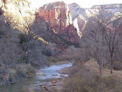 The sun rises in the canyon.  There are many walking trails in the park but in designated areas to protect this magnificent asset. The trees beside the river are Fremont Cottonwoods planted to control erosion