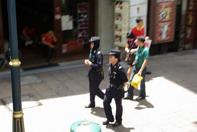 FRIDAY 17 OCTOBER 2008  Women have equal opportunity in employment and education in Malaysia. Wearing the scarf is optional as the Police woman (see the guns?) on the left shows.