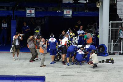 SATURDAY 18 OCTOBER 2008   It's a hive of frantic activity. The seconds remaining in the session are quickly counting down. The chap in the red and white shirt is Rossi's Bridgestone tyre technician.