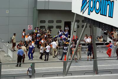 SATURDAY 18 OCTOBER 2008  The fellow in the Repsol shirt standing next to the attractive lady is Alberto Puig, Pedrosa'a manager. He's holding Pedrosa's helmet and gloves while Pedrosa completes his interviews with the media.