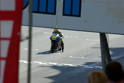 SUNDAY 19 OCTOBER 2008 - RACE DAY  The first thing the riders do during warmup is a practice start. The red light reflecting in Rossi's helmet is from his bike's rev-limiter.