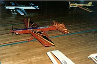 1986 US Nationals at Lake Charles Louisiana  Brian's plane at concourse judging. I think this is the first plane to carry the  Firecracker  name.