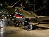 The CURTISS P-40E WARHAWK   was the United States' best fighter available in large numbers when World War II began. P-40s engaged Japanese aircraft at Pearl Harbor and in the Philippines in December 1941. They also served with the Flying Tigers in China in 1942 and in North Africa in 1943 with the 99th Fighter Squadron, the first African-American U.S. fighter unit.  More than 14,000 P-40s were built serving the air forces of 28 nations. : 2009-11-04 USA Air Force Museum