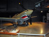 The aircraft on display is a Kittyhawk (the export version of the P-40E built for the RAF). It is painted to represent the aircraft flown by Col. Bruce Holloway, a pilot in both the Flying Tigers and its successor Army Air Forces unit, the 23rd Fighter Group. : 2009-11-04 USA Air Force Museum