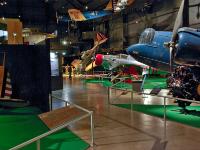 Looking towards the exit of the Early Years Gallery. The plane with the red cowl is a NORTHROP A-17A while the "crashed" plane near the exit is a NORTH AMERICAN BT-14 (NA-64) trainer. : 2009-11-04 USA Air Force Museum