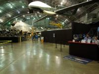 I'm now looking at the southern part of the middle hangar which features aircraft used in the Korean War. To the right is a simullated ride in an F-16  and above hangs a Northrop Grumman RQ-4 Global Hawk : 2009-11-04 USA Air Force Museum