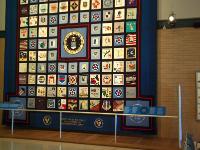 This is the USAF's 50th Anniversay (in 1997) Commemorative Quilt.  It contains 100 hand-made squares representing nearly every USAF installation throughout the world with each square reflecting its mission. The quilt centre features the Air Force seal and is surrounded by the seals of each major Air Force command. : 2009-11-04 USA Air Force Museum