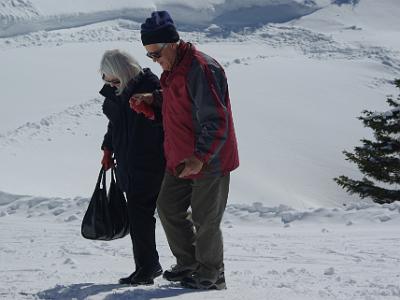 This old couple seemed to be having trouble walking on the snow.