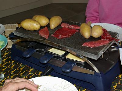 Thursday 2009-04-02  &nbsp;&nbsp;&nbsp;  At Michele's place in Romanswiller, France   This is a device with a hot stone (pierrade) on top on which you cook meats like sliced raw fillet, prawns, potatoes and Viande de Gryson from Switzerland.  Underneath is space for about eight cheese trays where you melt the cheese and mix it with meat, potatoes or prawns.