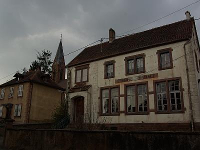 The school house has writing in French over the top of German as Alsace changed between France and Germany.