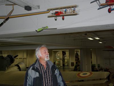 Sunday 2009-03-29&nbsp;&nbsp;&nbsp;   Deutsches Museum - Munich  There is also a display of model aeroplanes at the museum.  Claus poses with one of the models he gave to the museum, the red biplane overhead.