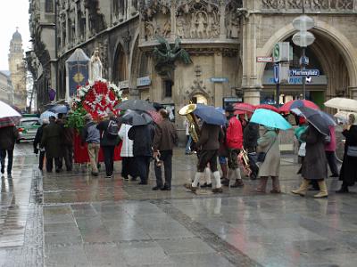 Sunday 2009-03-29&nbsp;&nbsp;&nbsp;     Munich City Centre   Easter is only two weeks away and these brave souls defy the cold and rain to transport a Marian effigy to the Theatinerkirche visible in the distance.