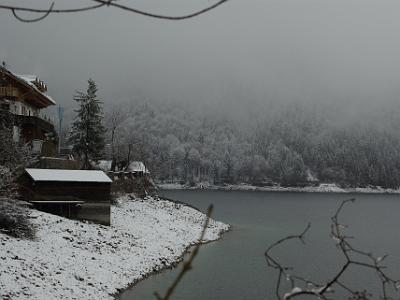 Monday 2009-03-30&nbsp;&nbsp;&nbsp;   On the B11 to Mittenwald   House on the water's edge, snow, trees shrouded in mist - beautiful.  Look at the water marks on the boat shed indicating where the water comes to during the summer months.  In winter, water is released to generate hydro-elecricity.