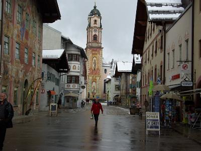 Monday 2009-03-30&nbsp;&nbsp;&nbsp;    Mittenwald   The tower of the Roman Catholic church of Saints Peter and Paul is visible in the background. The building to the left, with the dog waiting patiently, is highly decorated.