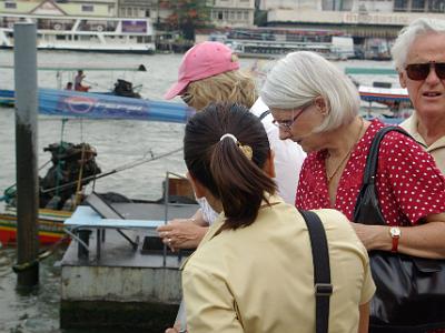 Tuesday 2009-04-07&nbsp;&nbsp;&nbsp;  Chao Phraya River   They're looking at a school of catfish swimming in the water below.