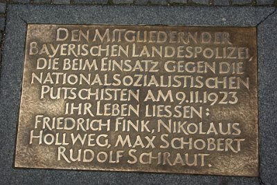 Monday 21  June, 2010  This plate is discretely placed near the site of the killings. Rough translation: "The members of the Bavarian Police,  who gave their lives opposing the National Socialist coup on November 9th, 1923: Frederick Fink, Nicholas Hollweg, Max Schobert, Rudolf Schraut."  Sixteen Nazis also died in the Putsch. Hitler escaped but was later arrested. : 22010-06-21 Munich