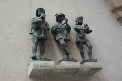 Thursday 24  June, 2010  On the north side of the Karlstor's main arch there is a memorial for Herbert Jensen  who proposed the creation of a pedestrian zone.   The three children  playing music were sculpted by Konrad Knoll  who also created the fish fountain in Marienplatz. : 2010-06-24 Munich