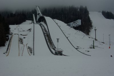 Thursday 1 July, 2010  When we came here last year, it looked more menacing.  The box sticking out on the right is where the five "style" judges sit. They award points out of 20 for the flight and the landing. A "telemark" landing is required which is where one foot is in front of the other. The judges also agree on the gate position as it is dangerous if the athletes exceed the hill size by too much.